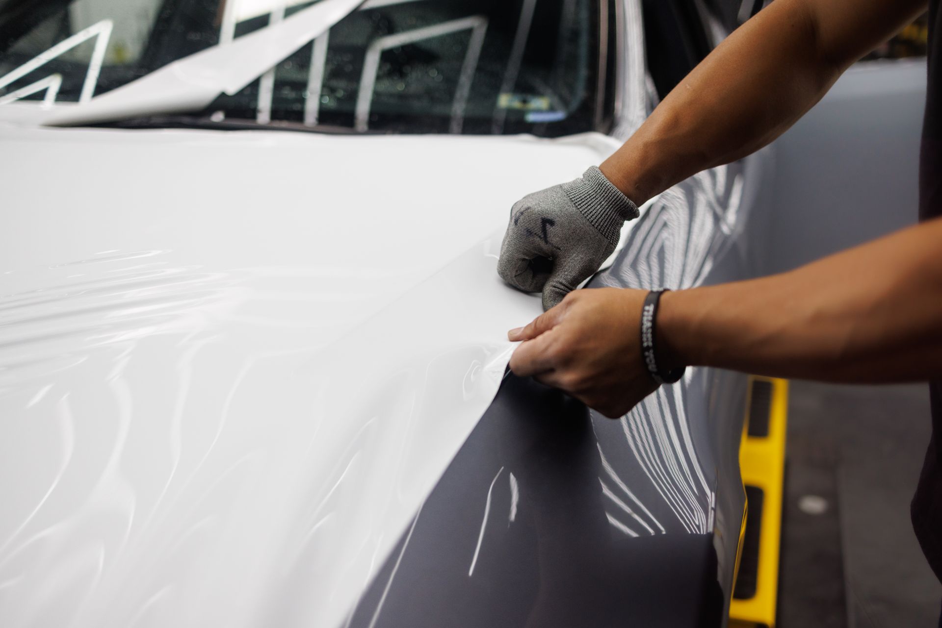 Paint protection film being applied to a vehicle