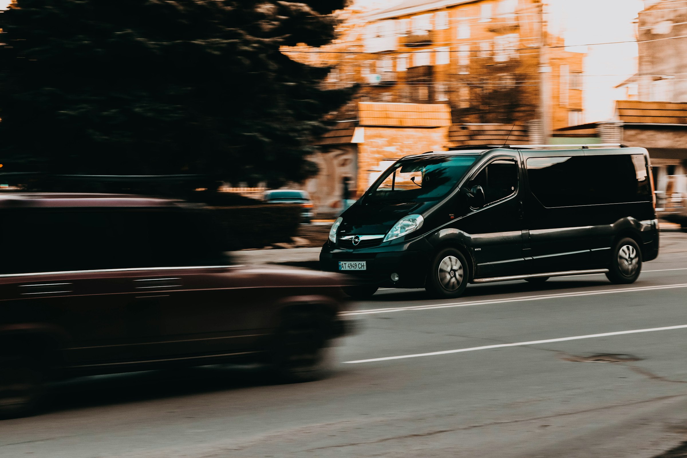 Black work van moving through the city
