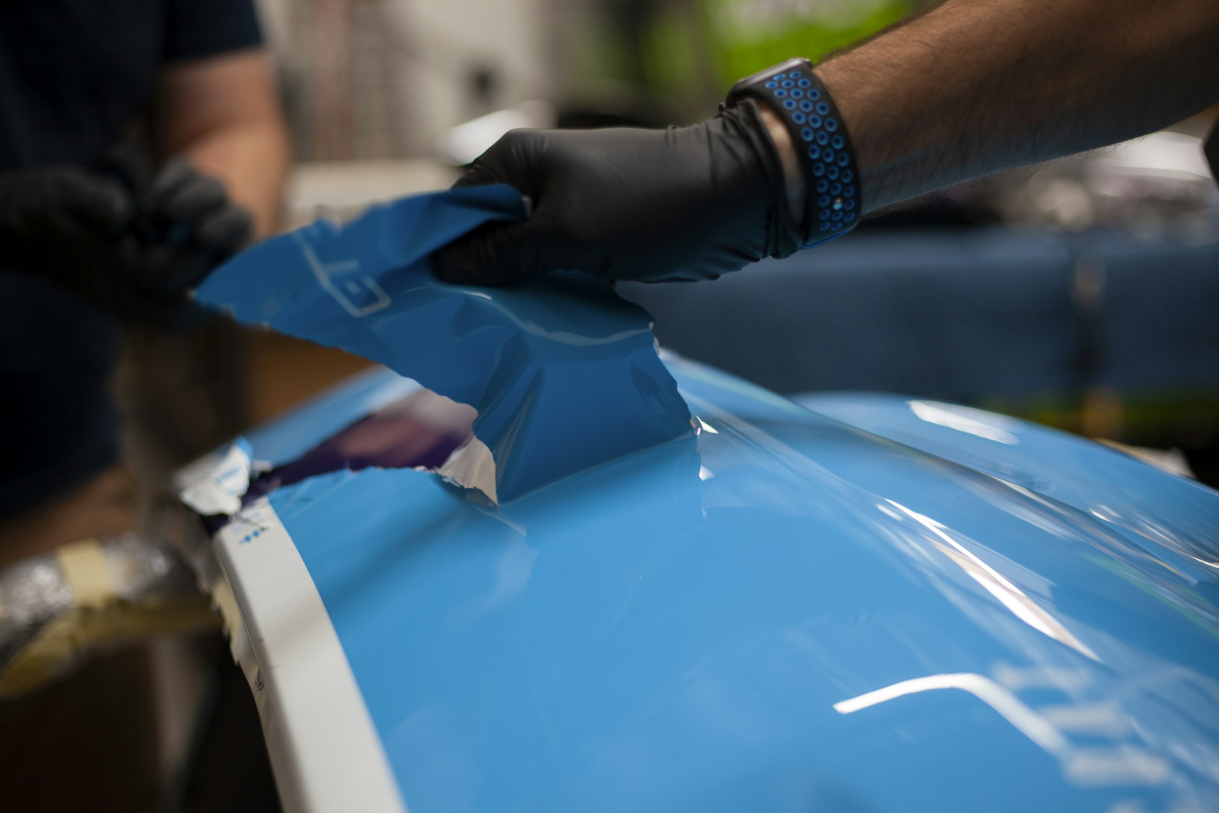 Protective film being applied to a car panel